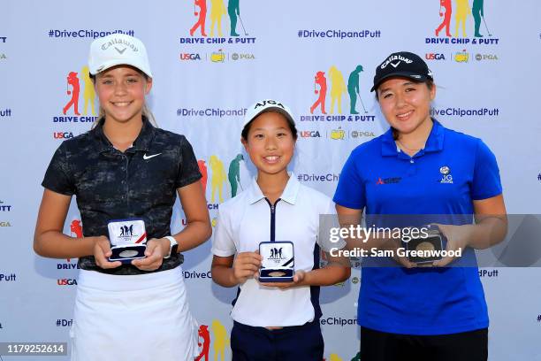 Girls 12-13 driving top three , Kinslea Jones 2nd, Maye Huang 1st, and Sophie Christopher 3rd, pose with their medals during a regional round for The...