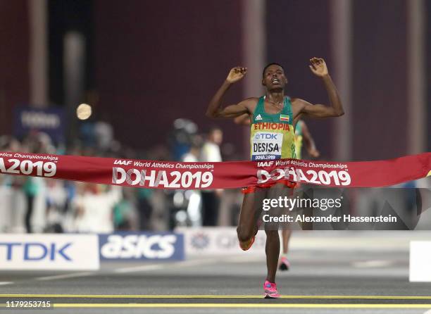 Lelisa Desisa of Ethiopia crosses the finish line to win the Men's Marathon during day nine of 17th IAAF World Athletics Championships Doha 2019 at...