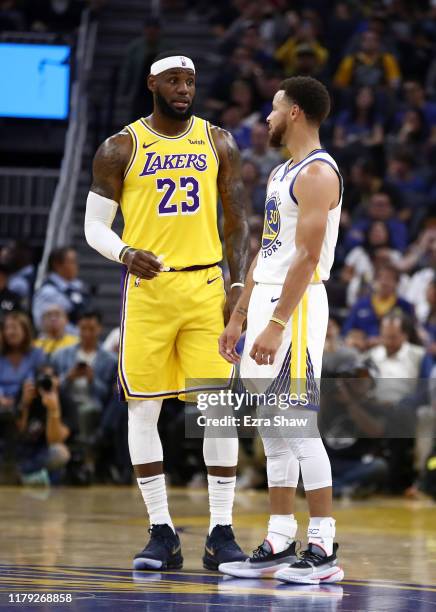 LeBron James of the Los Angeles Lakers talks to Stephen Curry of the Golden State Warriors during their game at Chase Center on October 05, 2019 in...