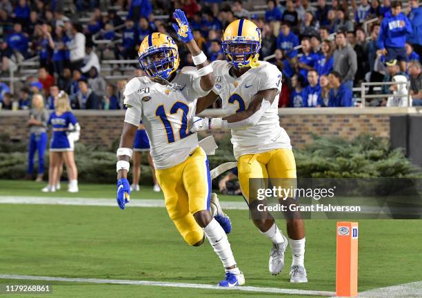 Paris Ford celebrates with teammate Damar Hamlin of the Pittsburgh Panthers after returning an interception for a touchdown against the Duke Blue...