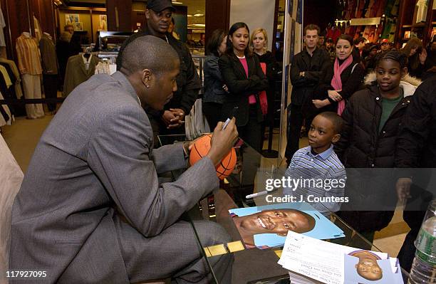 Jamal Crawford signs autographs for fans during Perry Ellis and Travel & Leisure Magazine Host In-Store Appearance by NBA Star Jamal Crawford at...