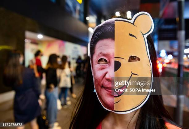 Protester wearing a Winnie the Pooh and Xi Jinping mask during the demonstration. Protesters at Halloween march in Hong Kong island despite police...