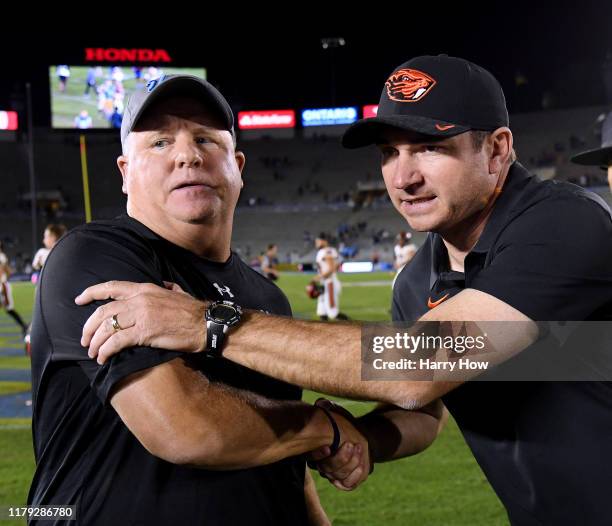 Head coach Chip Kelly of the UCLA Bruins shakes hands with head coach Jonathan Smith of the Oregon State Beavers after a 48-31 Oregon State win at...