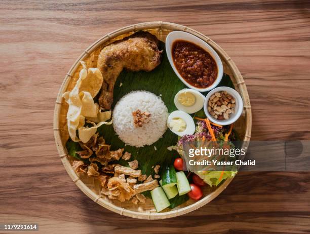 nasi lemak on a traditional bamboo tray - traditional malay food stock pictures, royalty-free photos & images
