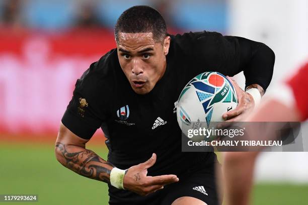 New Zealand's scrum-half Aaron Smith runs with the ball during the Japan 2019 Rugby World Cup bronze final match between New Zealand and Wales at the...