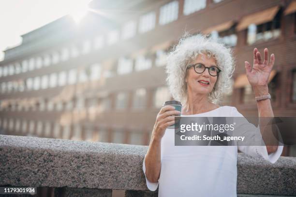 senior woman drinking coffee - curly waves stock pictures, royalty-free photos & images