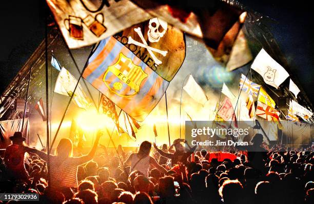 General view of the flags and crowd in front of the Pyramid stage as Kanye West performs live during the second day of Glastonbury Festival at Worthy...
