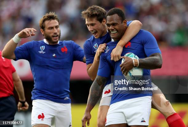 Virimi Vakatawa of France celebrates with teammates after scoring his team's first try during the Rugby World Cup 2019 Group C game between France...