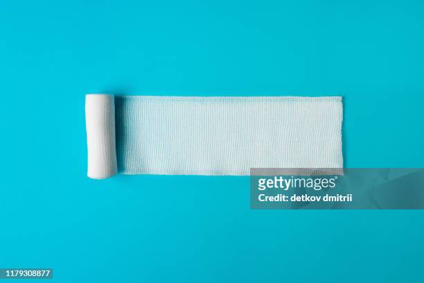 medical bandage untwisted on a blue background. health concept. healthy lifestyle concept. the concept of pharmacology. the concept of medicines. the concept of medical instruments. medicine concept. - bandage 個照片及圖片檔
