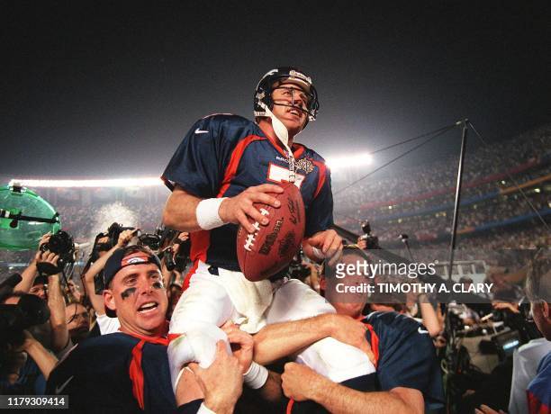 Denver Broncos quarterback John Elway is carried by teammates Ed McCaffrey and Bubby Brister after the Broncos defeated the Green Bay Packers 31-24...