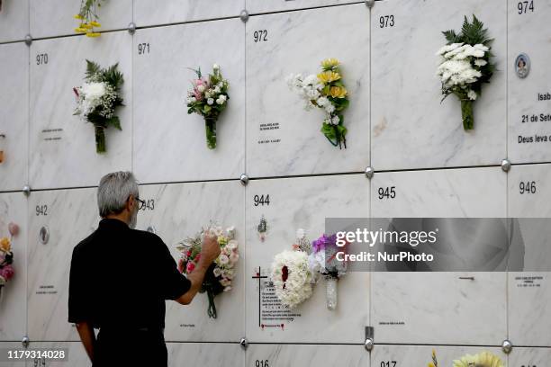 Man visits the grave of a relative at a cemetery during the annual observance of All Saint's Day in Oeiras, Portugal on November 1, 2019. Portuguese...