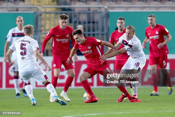 Johannes Geis of 1. FC Nuernberg, Gino Fechner of 1. FC Kaiserslautern and Hanno Behrens of 1. FC Nuernberg during the DFB Cup second round match...