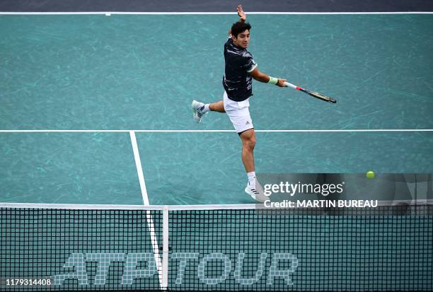 Chile's Christian Garin returns the ball to Bulgaria's Grigor Dimitrov during their men's singles quarter-final tennis match at the ATP World Tour...