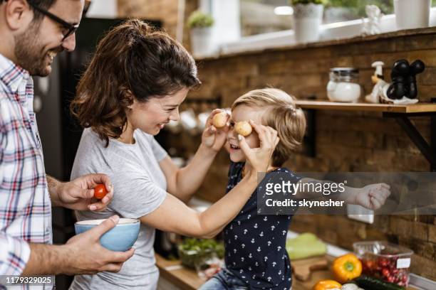 happy parents having fun with their small son in the kitchen. - mother food imagens e fotografias de stock