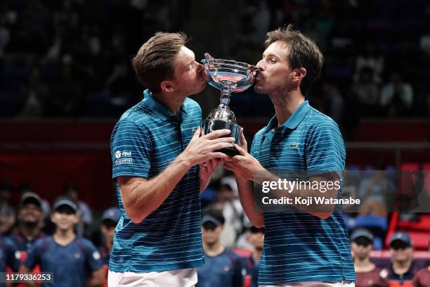 Nicolas Mahut and Edouard Roger-Vasslin of France pose with the trophy after winning their men's doubles final against Nikola Mektic and Franko...