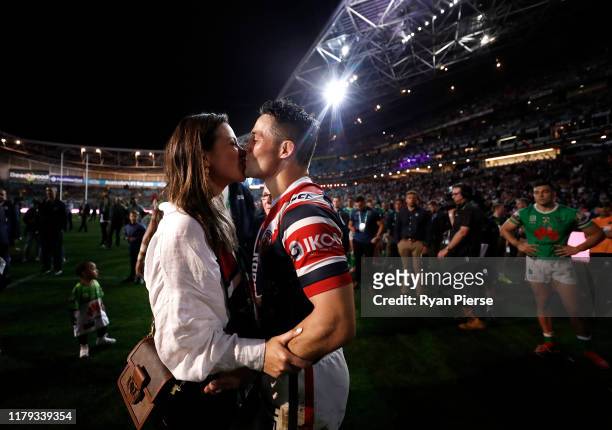 Cooper Cronk of the Roosters kisses his wife Tara Rushton after the 2019 NRL Grand Final match between the Canberra Raiders and the Sydney Roosters...