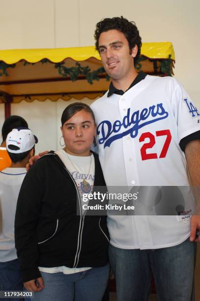 Los Angeles Dodgers pitcher D.J. Houlton poses with a young female fan at the team's annual children's holiday party at Dodger Stadium in Los...