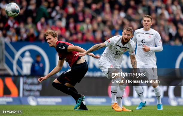 Asger Soerensen of Nuremberg is challenged by Marvin Knoll of St. Pauli during the Second Bundesliga match between 1. FC Nuernberg and FC St. Pauli...