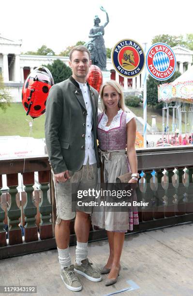 Goalkeeper Manuel Neuer of FC Bayern Muenchen and his wife Nina Neuer attend the Oktoberfest at Kaefer Wiesenschaenke tent at Theresienwiese on...