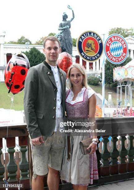 Goalkeeper Manuel Neuer of FC Bayern Muenchen and his wife Nina Neuer attend the Oktoberfest at Kaefer Wiesenschaenke tent at Theresienwiese on...