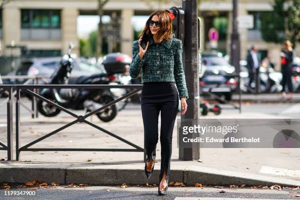 Christine Centenera wears sunglasses, a green tweed jacket with buttons and shoulder pads, outside Miu Miu, during Paris Fashion Week - Womenswear...