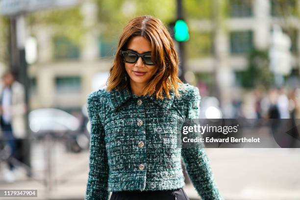 Christine Centenera wears sunglasses, a green tweed jacket with buttons and shoulder pads, outside Miu Miu, during Paris Fashion Week - Womenswear...