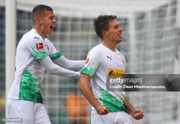 Patrick Herrmann of Borussia Monchengladbach celebrates with teammate Laszlo Benes after scoring his team's second goal during the Bundesliga match...