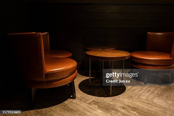 lights were placed on leather chairs and round tables in the corners - antique sofa styles foto e immagini stock