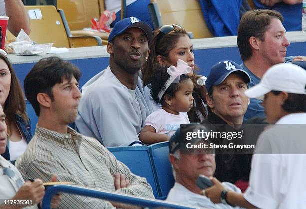 Kobe Bryant sits with his daughter and wife Vanessa during the Los Angeles Dodgers contest against the New York Yankees at Dodger Stadium, June 20,...