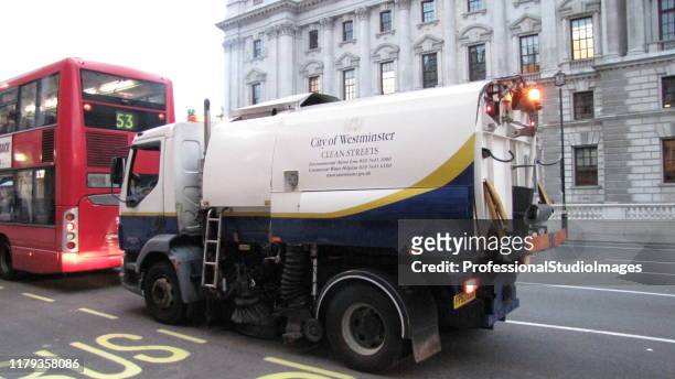 garbage truck in the city of london - garbage truck driving stock pictures, royalty-free photos & images