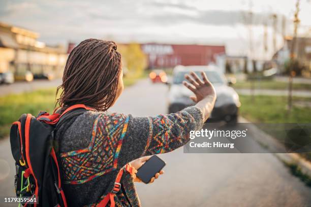 woman with backpack waving - curly waves stock pictures, royalty-free photos & images