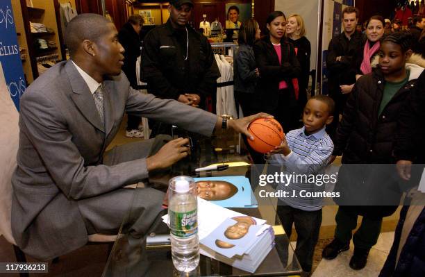 Jamal Crawford signs autographs for fans during Perry Ellis and Travel & Leisure Magazine Host In-Store Appearance by NBA Star Jamal Crawford at...
