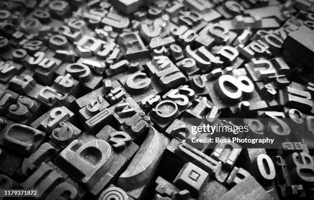 typescript metal letters seen in a flea market - scriptwriter foto e immagini stock