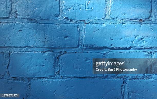 brick wall painted in blue - banging your head against a wall stock pictures, royalty-free photos & images