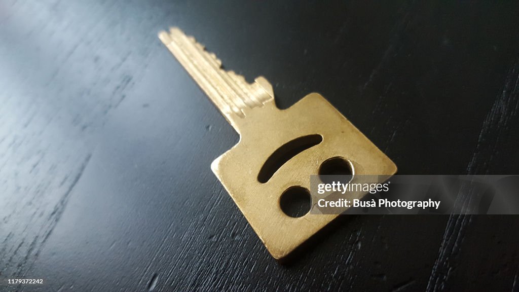 Key carved with smiling face