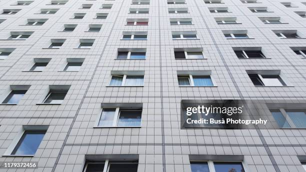facade of prefabricated housing (plattenbau) in east berlin, germany - berlin modernism housing estates stock pictures, royalty-free photos & images