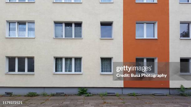 facade of prefabricated housing (plattenbau) in east berlin, germany - house windows stock-fotos und bilder