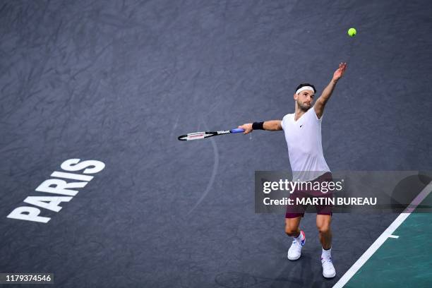 Bulgaria's Grigor Dimitrov eyes the ball as he serves the ball to Chile's Christian Garin during their men's singles quarter-final tennis match at...