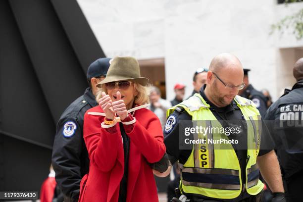 Actress Jane Fonda is arrested by U.S. Capitol Police officers during a ''Fire Drill Fridays'' climate change protest inside the Hart Senate Office...