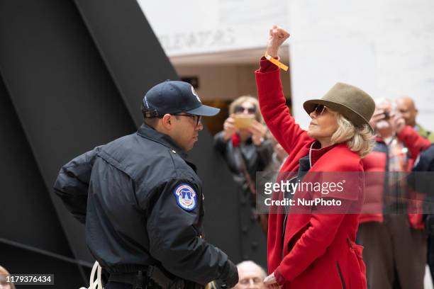 Actress Jane Fonda is arrested by U.S. Capitol Police officers during a ''Fire Drill Fridays'' climate change protest inside the Hart Senate Office...