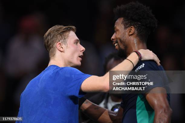 Canada's Denis Shapovalov is congratulated by France's Gael Monfils after winning their men's singles quarter-final tennis match of the ATP World...