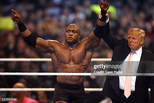 Donald Trump and WWE wrestler Bobby Lashley celebrate their victory over Vince McMahon at the main event of the night, "Hair vs. Hair", between Vince...