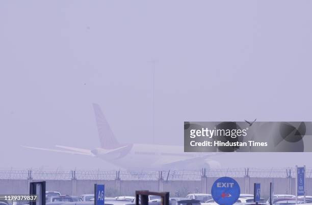 An Air-India aircraft is seen amid heavy smoke, at Terminal 3, IGI airport, on November 1, 2019 in New Delhi, India. While Delhi's air quality...