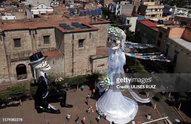 Aerial view of a 20-meter-high "Catrina" figure -the biggest in the world-, dressed up as a bride, and the "Catrin", her groom, in the main square of...