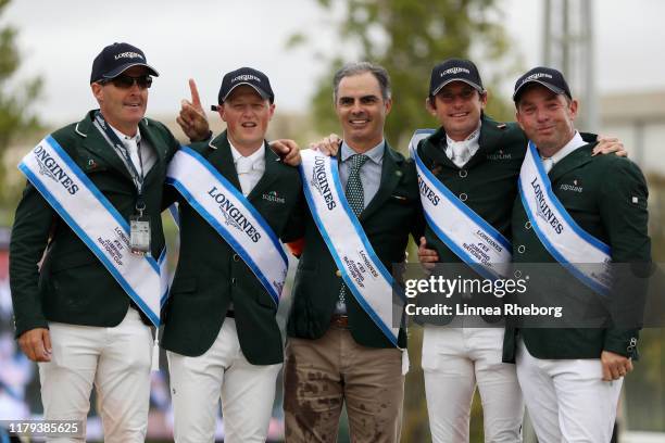 Paul O'Shea, Peter Moloney, Team Manager Rodrigo Pessoa, Darragh Kenny and Cian O'Connor of Ireland celebrate on the podium following their victory...