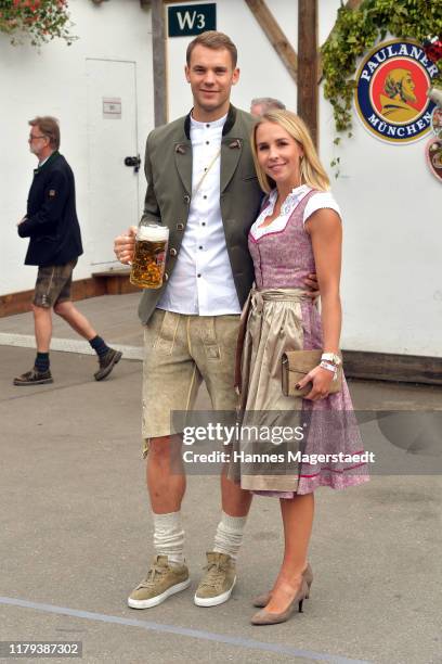 Goalkeeper Manuel Neuer of FC Bayern Muenchen and his wife Nina Neuer attend the Oktoberfest at Kaefer Wiesenschaenke tent at Theresienwiese on...