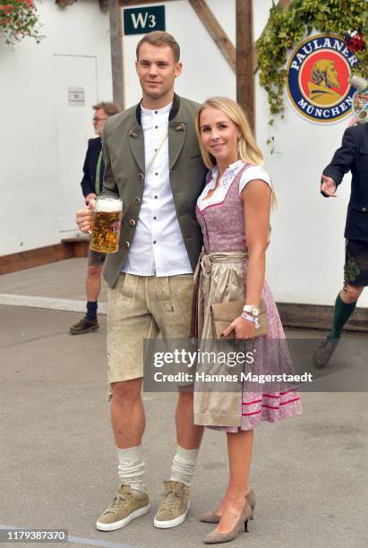 Goalkeeper Manuel Neuer of FC Bayern Muenchen and his wife Nina Neuer attend the Oktoberfest at Kaefer Wiesenschaenke tent at Theresienwiese on...