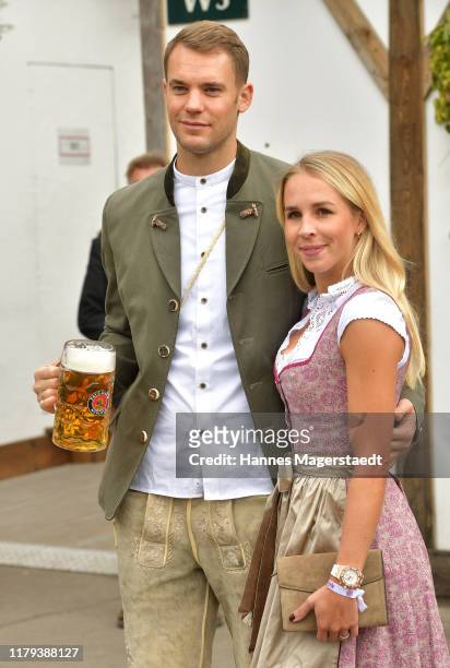 Goalkeeper Manuel Neuer of FC Bayern Muenchen and his wife Nina Neuer attend the Oktoberfest at Kaefer Wiesenschaenke tent at Theresienwiese on...