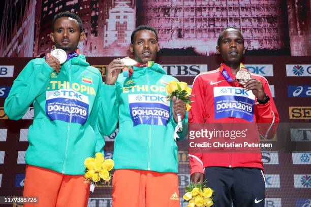 Lelisa Desisa of of Ethiopia, gold, Mosinet Geremewof of Ethiopia, silver, and Amos Kipruto of Kenya, bronze, pose during the medal ceremony for the...