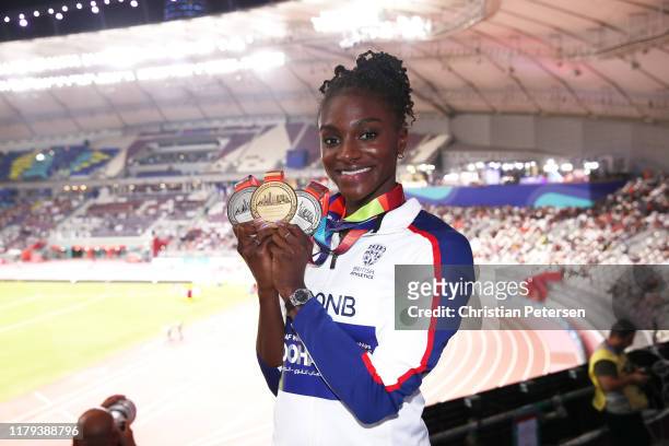 Dina Asher-Smith of Great Britain poses with her three championship medals during day ten of 17th IAAF World Athletics Championships Doha 2019 at...